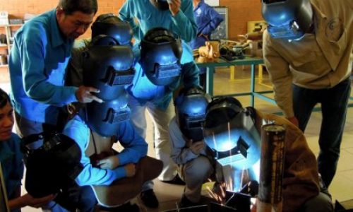 Trainees observing MIG welding demonstrated by the trainer