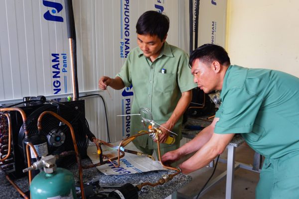 The teachers were connecting copper pipes with the outdoor unit