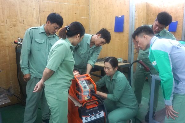 A teachers was adjusting MIG welding machine