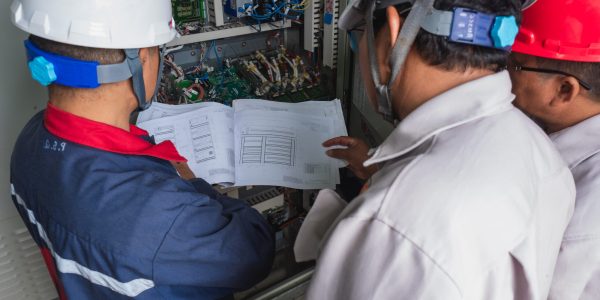 The operator shows how to read the detailed control circuit board of the turbine