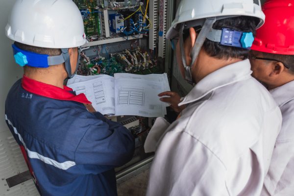 The operator shows how to read the detailed control circuit board of the turbine