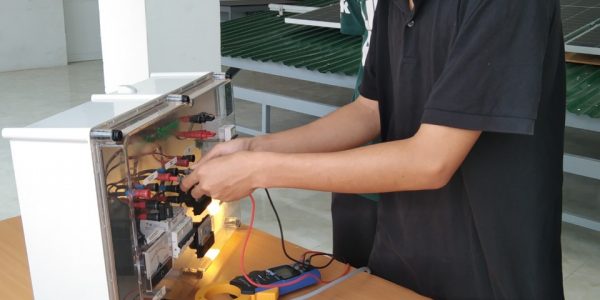 Young industry technician tests and operates the off-grid PV system.