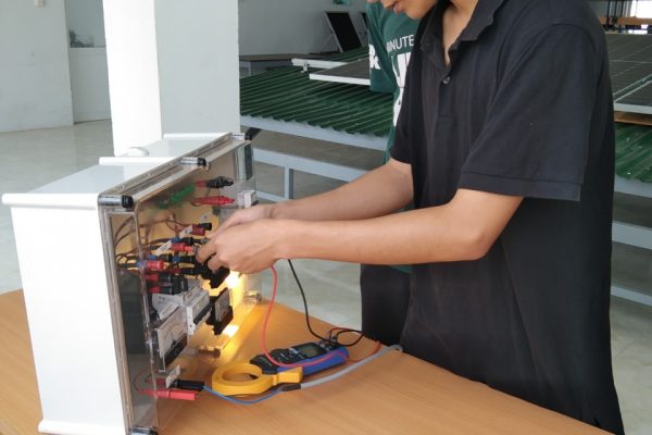 Young industry technician tests and operates the off-grid PV system.