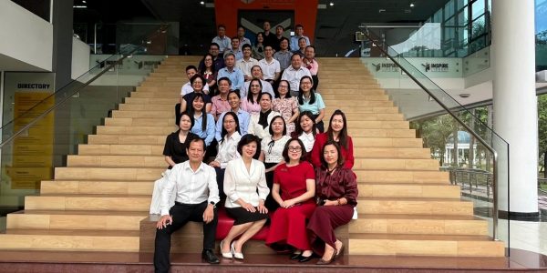 Participants taking a commemorative group photo at the library of Ton Duc Thang University.