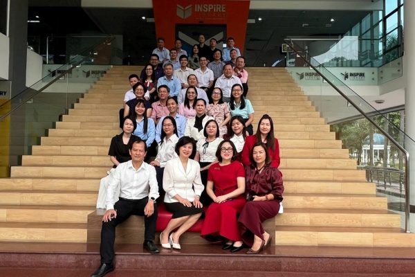 Participants taking a commemorative group photo at the library of Ton Duc Thang University.