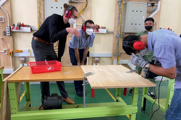 Mr Nguyen Hai Son was practicing the jig saw machine under supervisory of the trainers